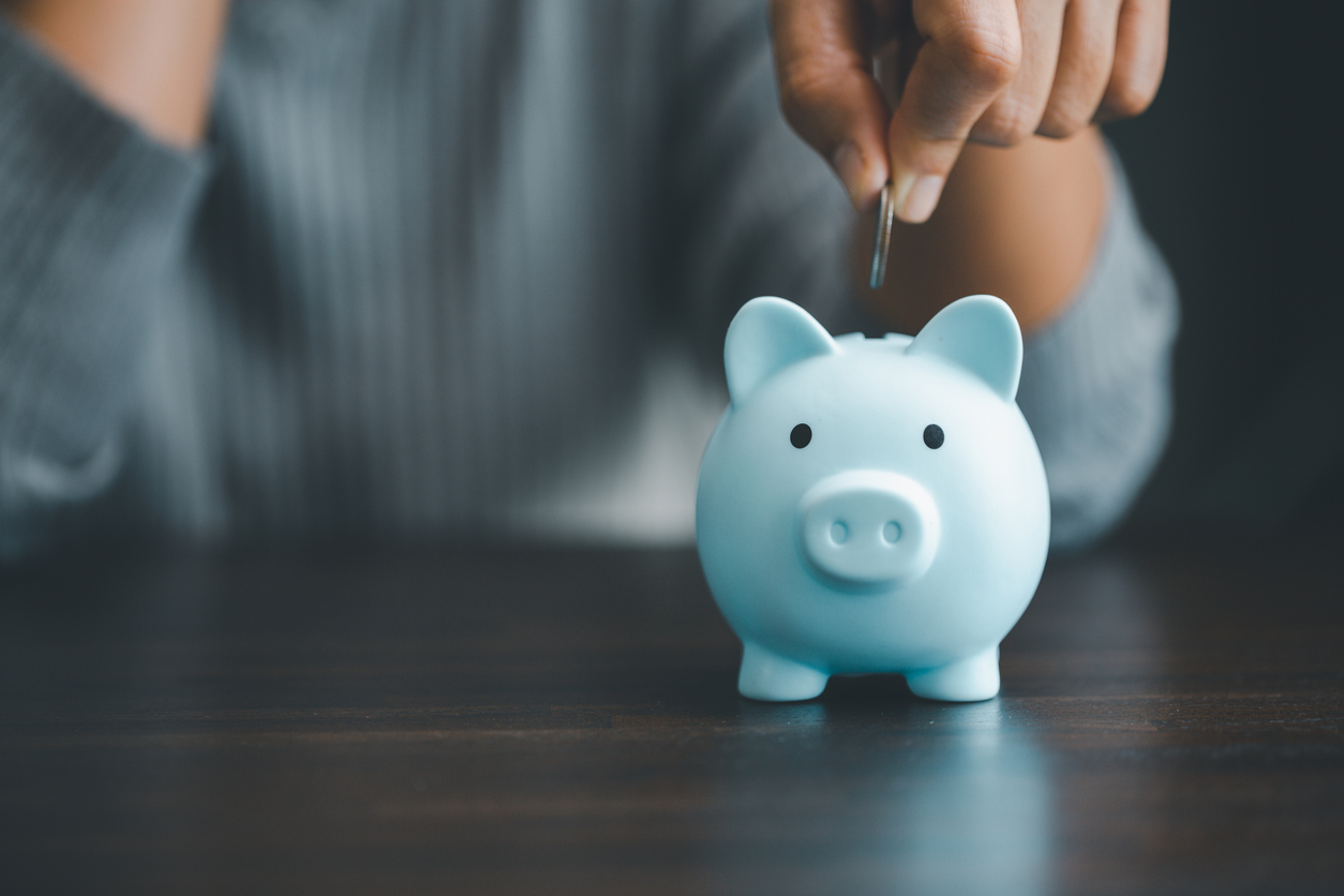 Saving investment banking finance concept. Stack of coins with piggy bank on the table. Growth of loan and investment business idea. Asset Management, Funds, Liabilities, Deposits, Income, Successful.